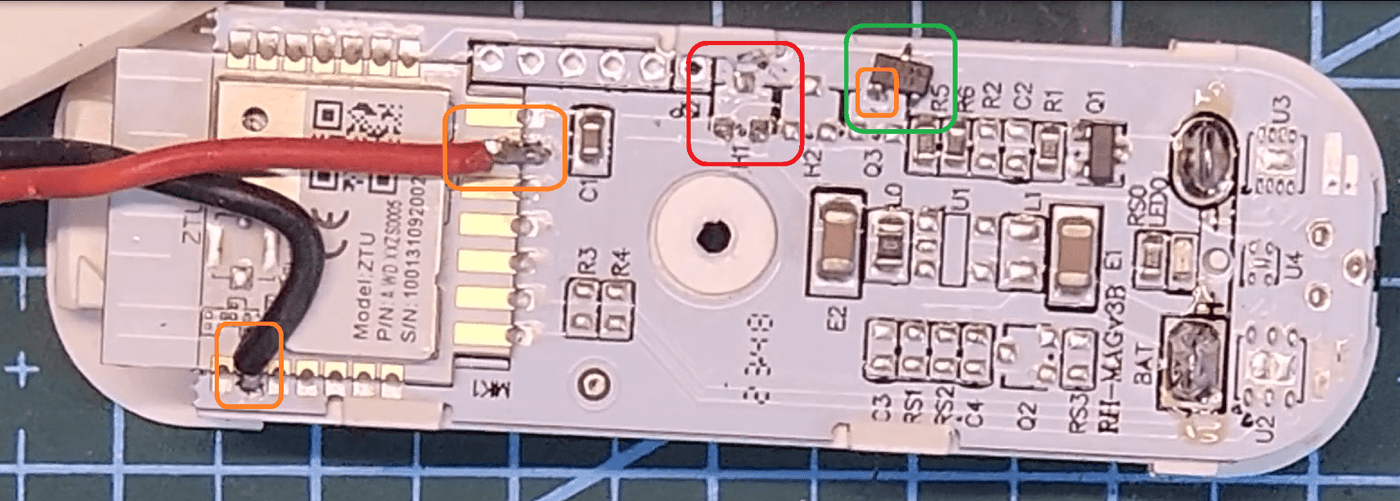 Zigbee door sensor PCB modified for an external contact (callouts show the removed chip, where it was parked, and the new wire joints)
